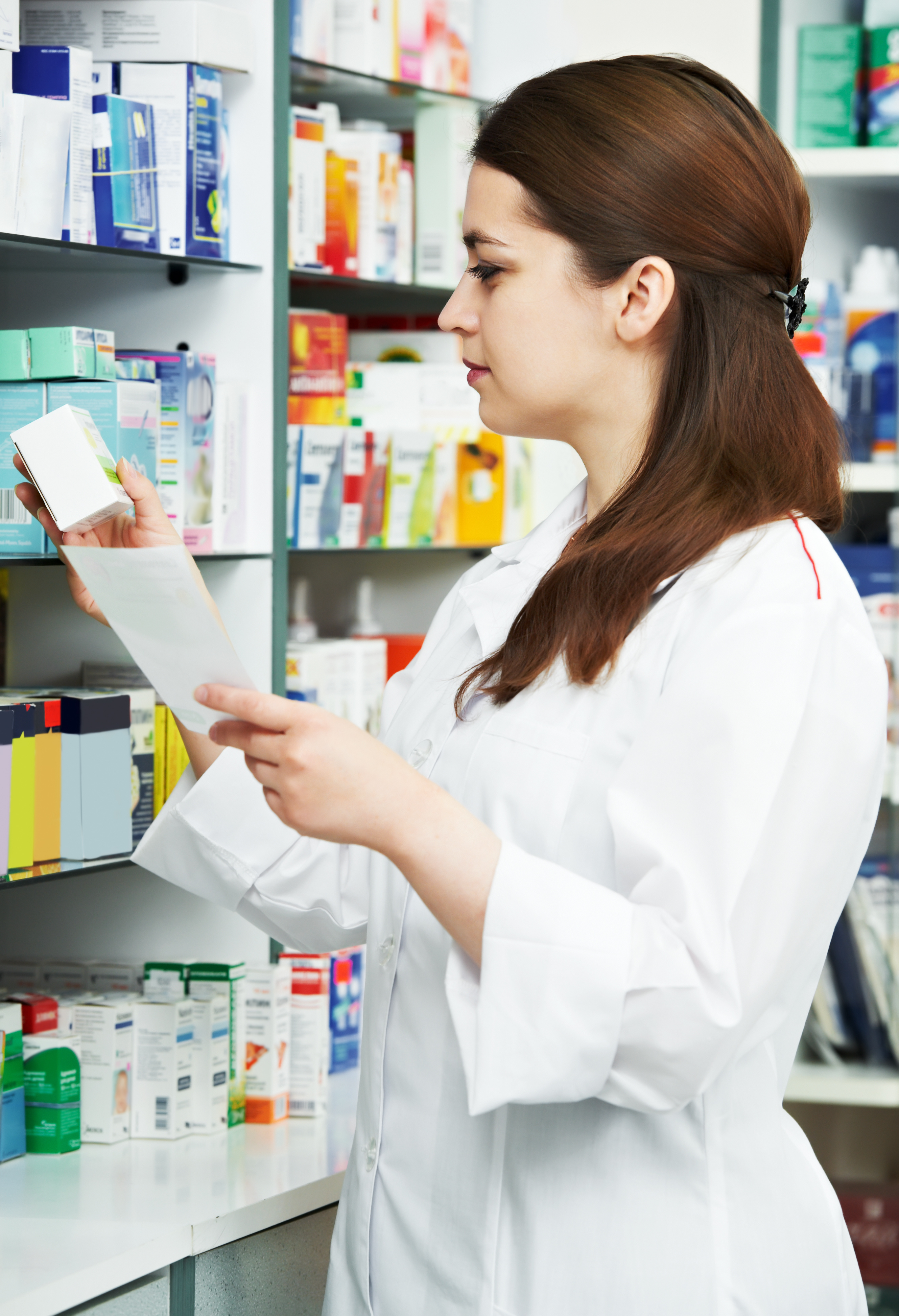 pharmacist chemist woman standing in pharmacy drugstore with recipe